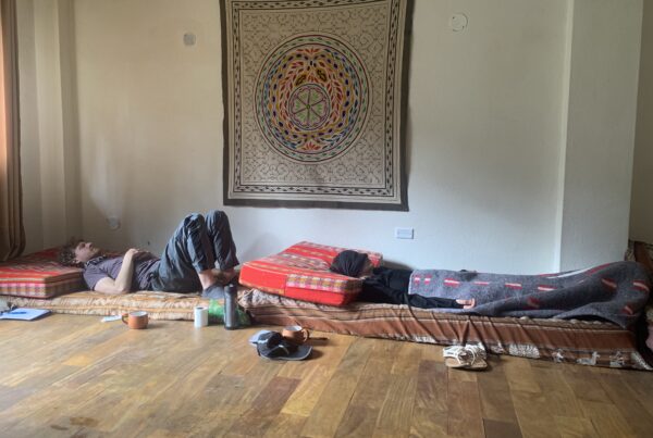 Participants in an ayahuasca ceremony lying on their beds