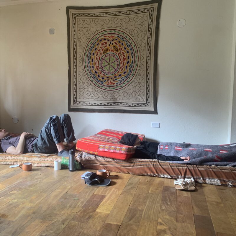 Participants in an ayahuasca ceremony lying on their beds