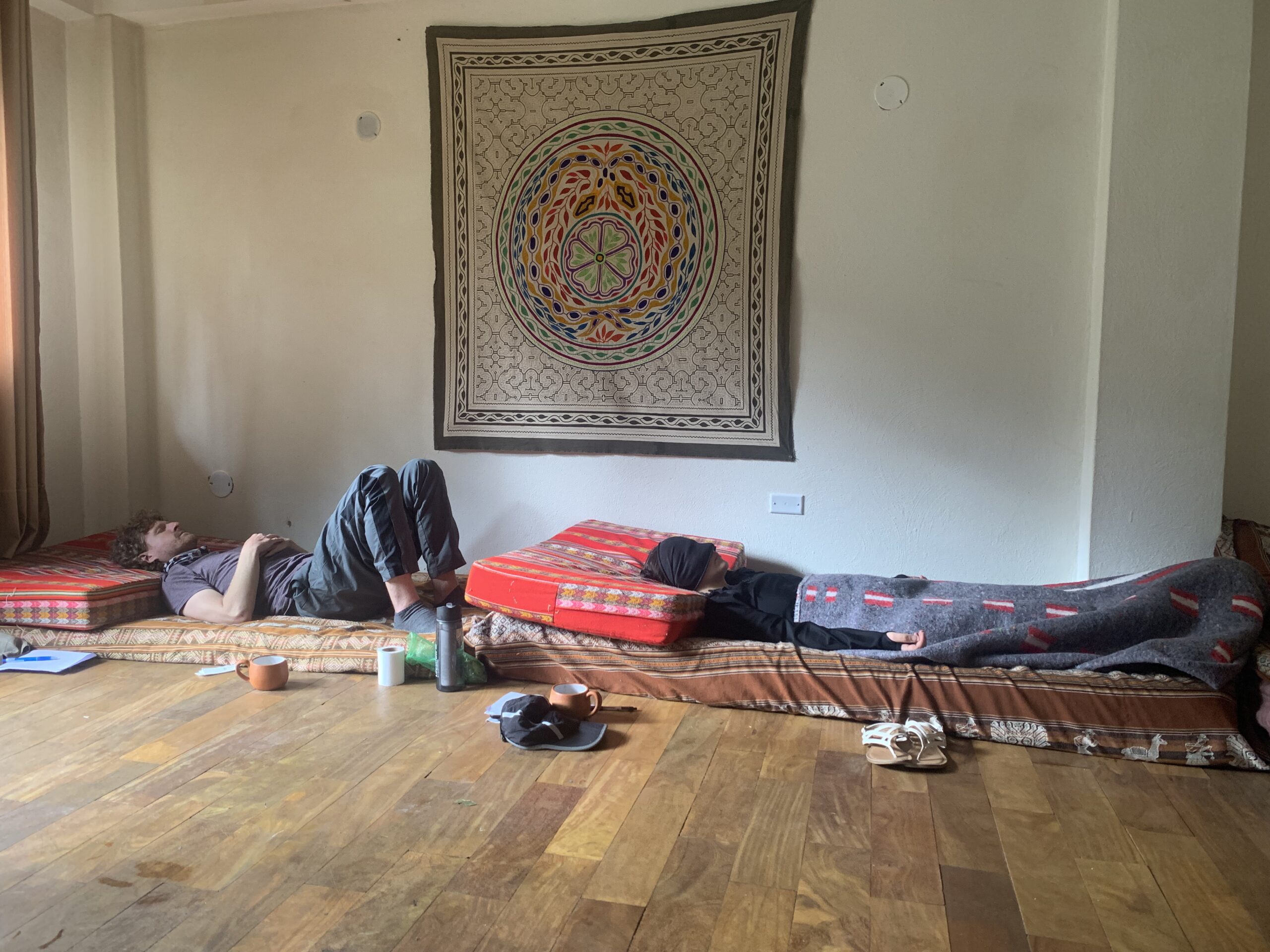 Participants in an ayahuasca ceremony lying on their beds
